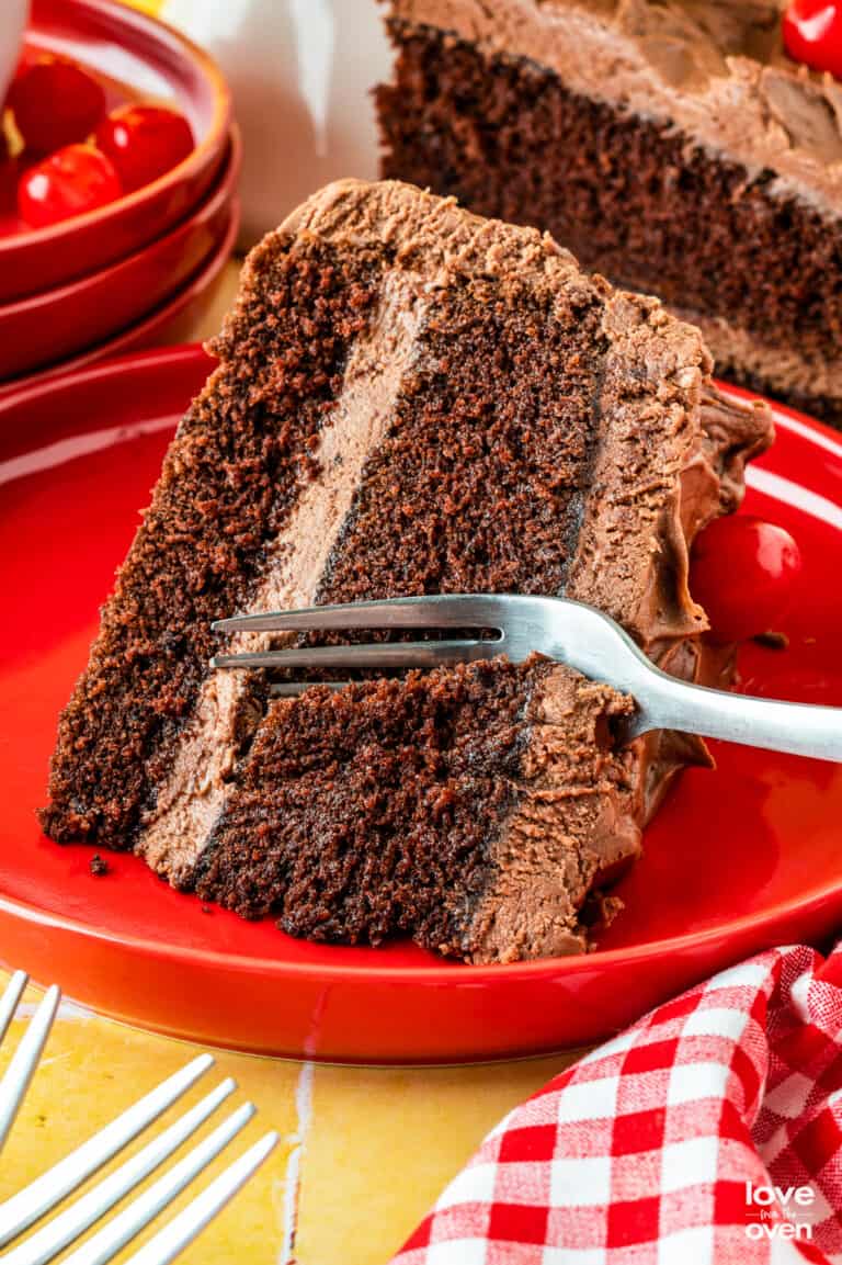 A fork taking a slice out of a mayonnaise cake