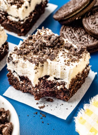 An oreo brownie topped with cream cheese frosting.