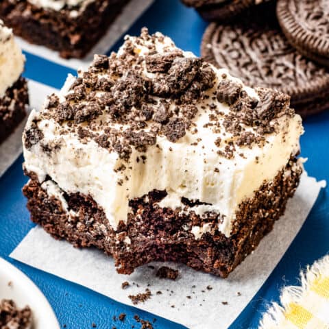 An oreo brownie topped with cream cheese frosting.