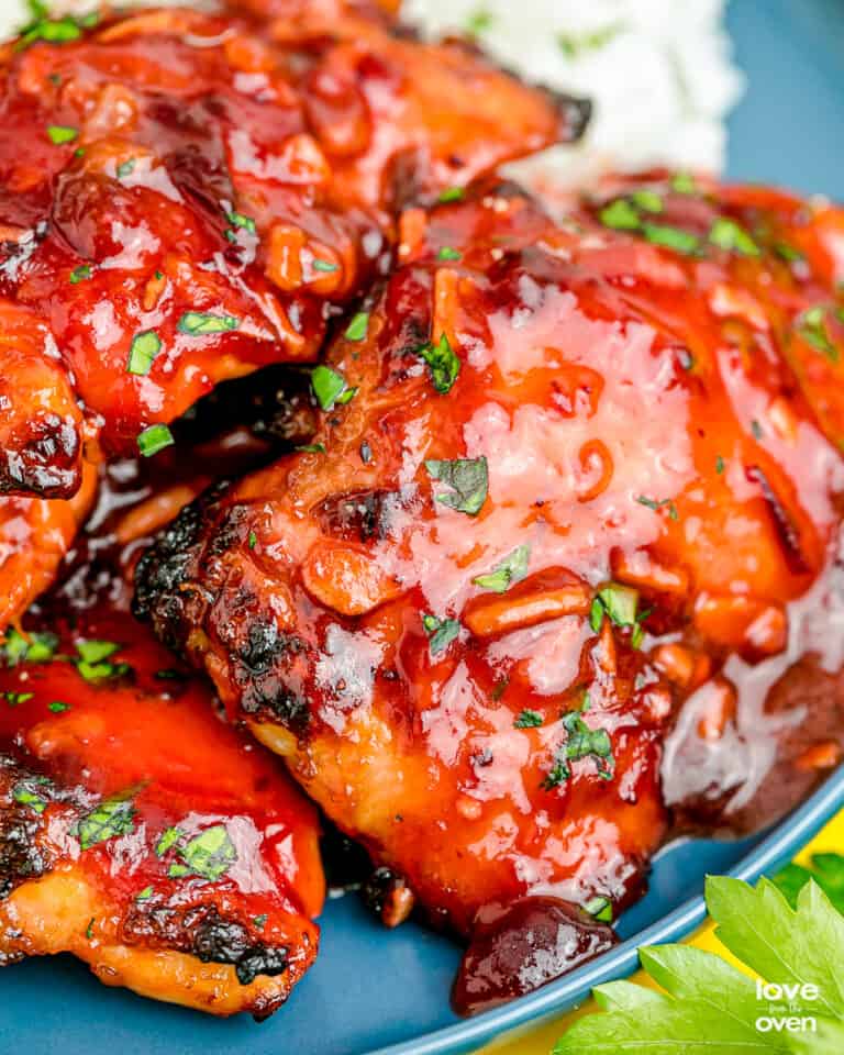 A close up of cranberry chicken on a plate.