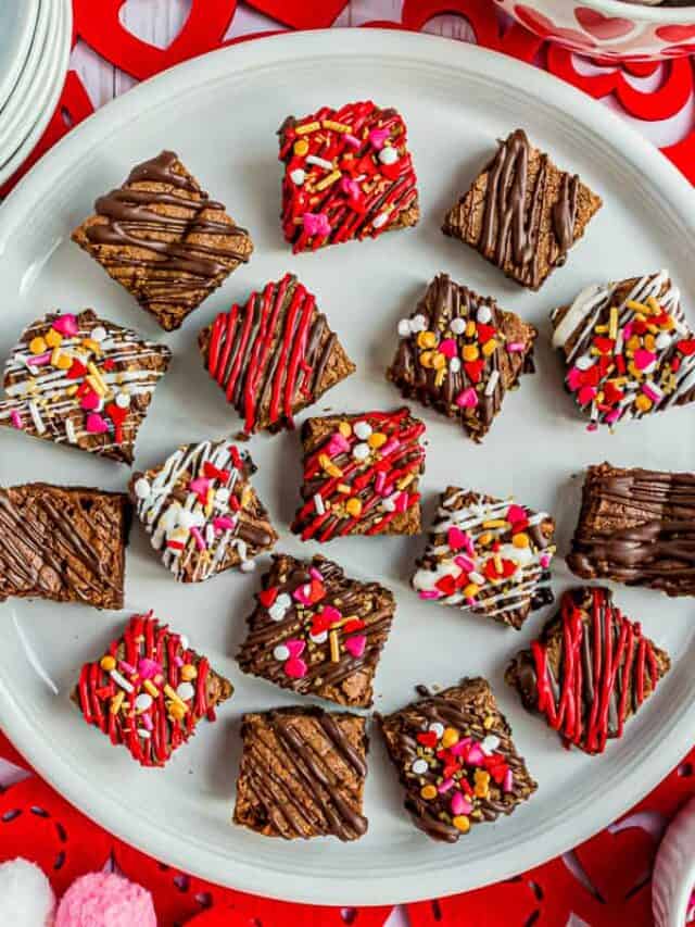 decorated valentine brownie bites on a white plate