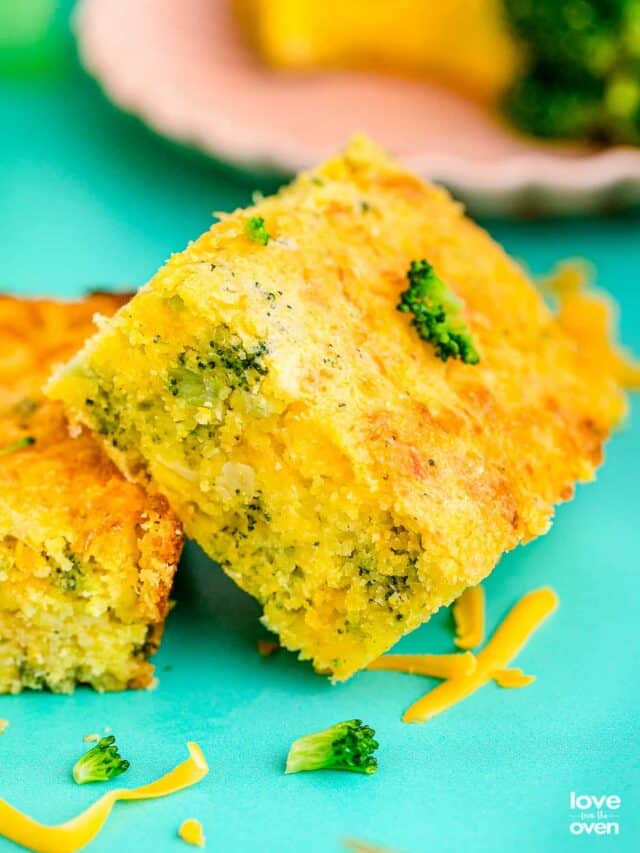 a slice of broccoli cornbread on a teal background
