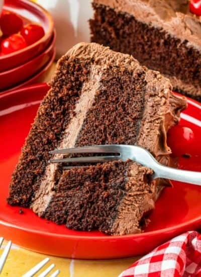 A fork taking a slice out of a mayonnaise cake