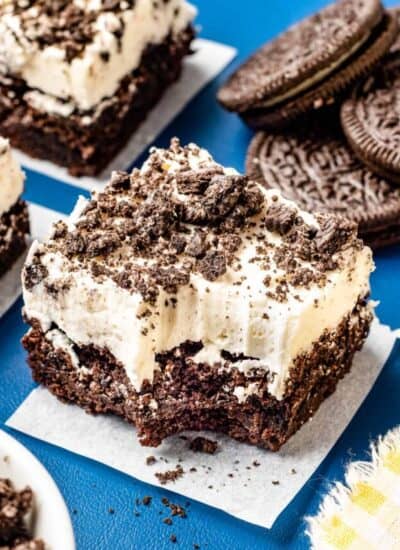 An oreo brownie topped with cream cheese frosting.