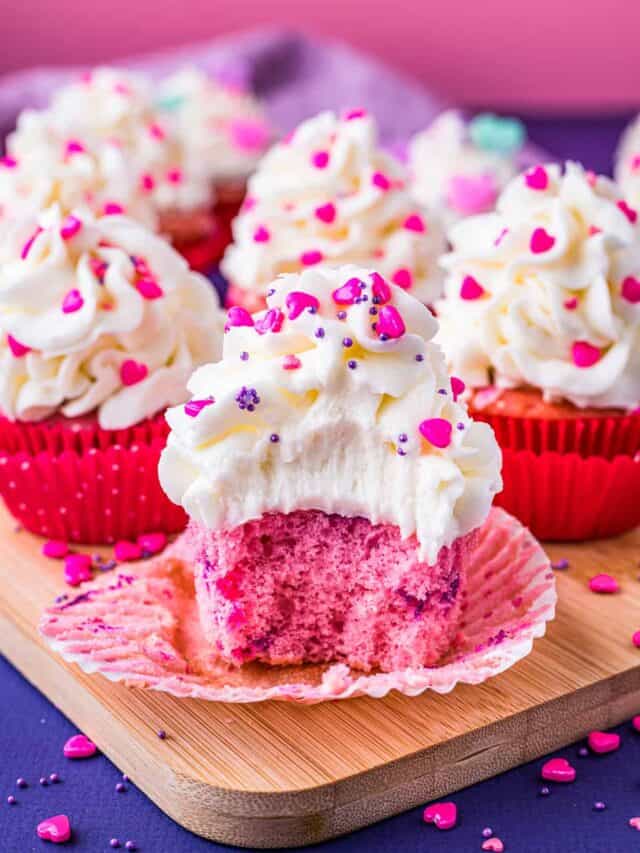 Pink velvet cupcakes on a purple and pink background.