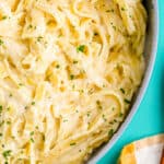 A pan full of copycat olive garden alfredo pasta in a pan.