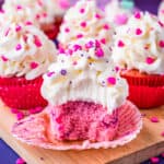 Pink velvet cupcakes on a purple and pink background.
