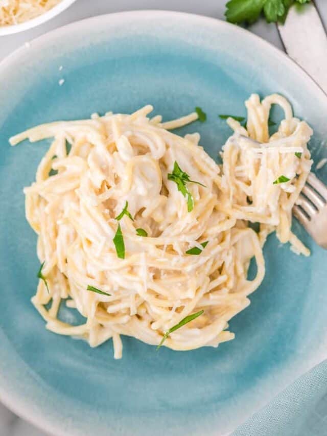 a plate of lemon butter pasta with a fork taking out a bite