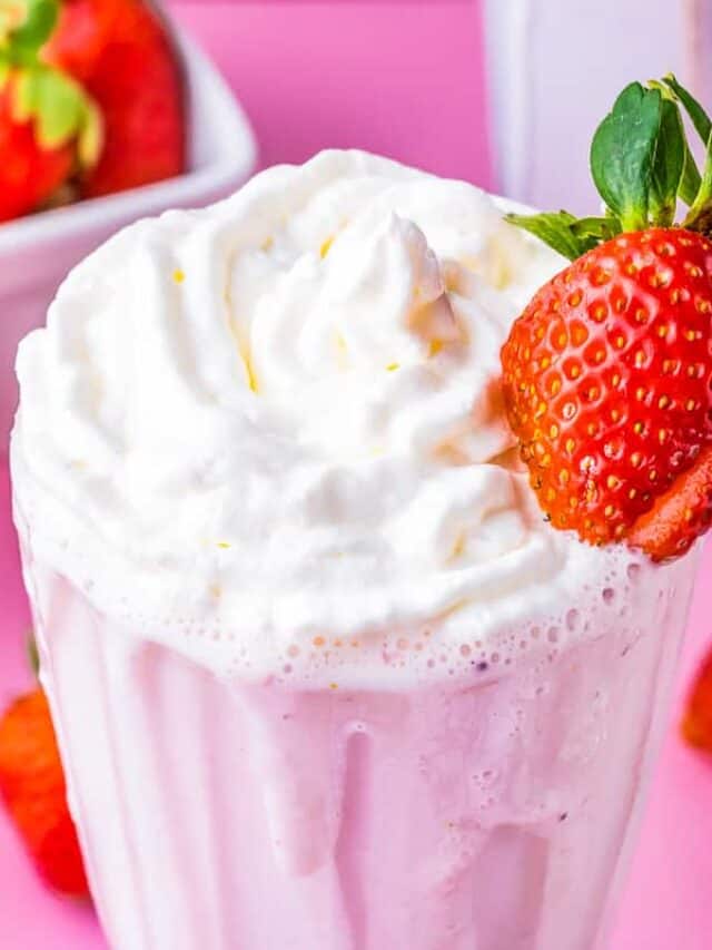 a strawberry milkshake with a strawberry on the side of it