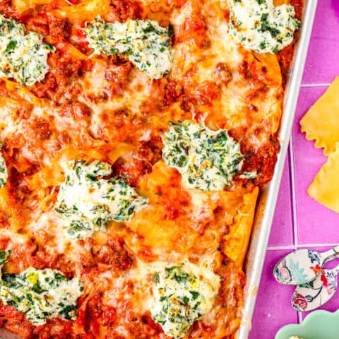 A sheet pan of lasagna on a purple background