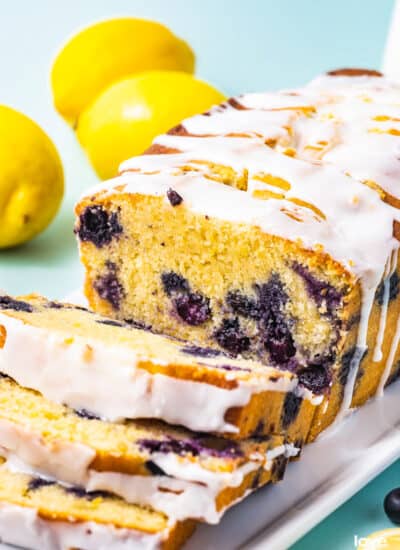 A loaf of lemon blueberry bread with lemon glaze