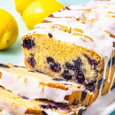 A loaf of lemon blueberry bread with lemon glaze