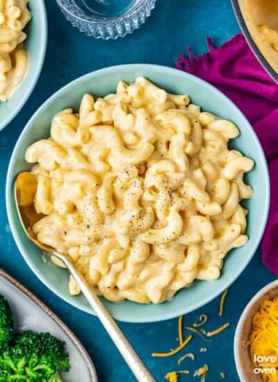 a bowl of mac and cheese on a dark blue background