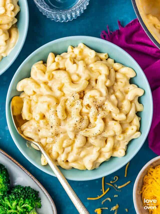 a bowl of mac and cheese on a dark blue background