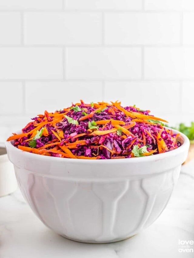 a large serving bowl of red cabbage slaw