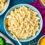 a bowl of mac and cheese on a dark blue background