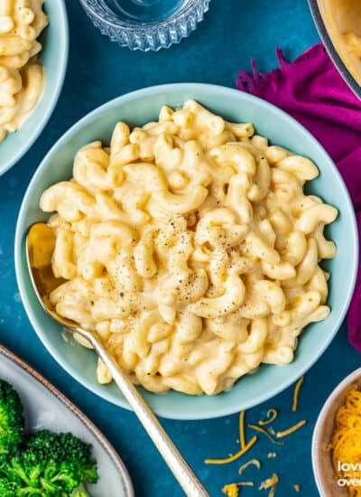 a bowl of mac and cheese on a dark blue background