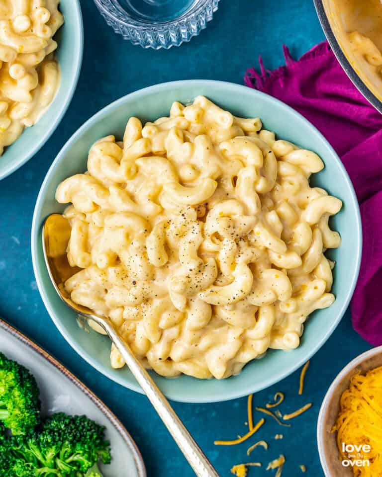 a bowl of mac and cheese on a dark blue background