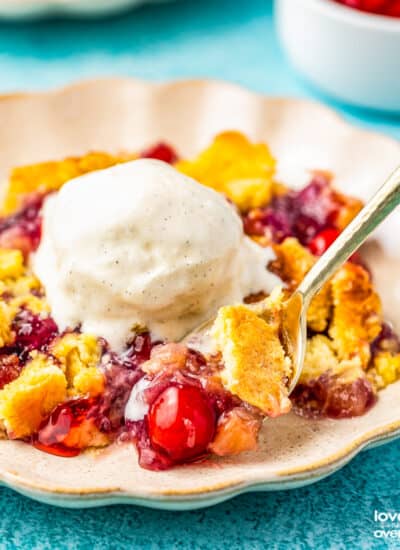 a plate of pineapple cherry dump cake