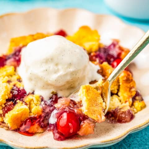 a plate of pineapple cherry dump cake