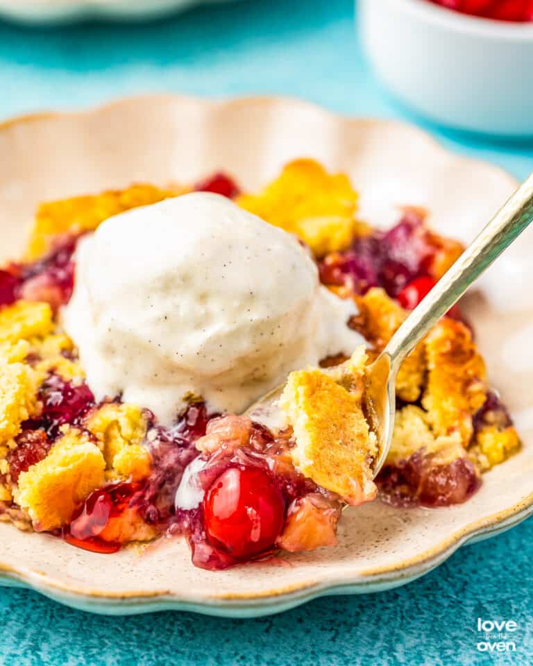 a plate of pineapple cherry dump cake
