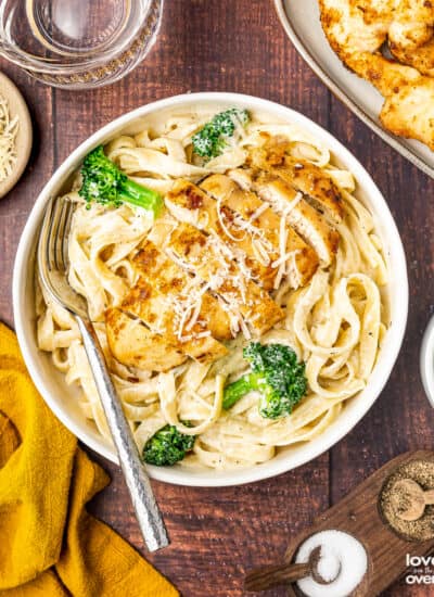broccoli chicken alfredo in a bowl with a fork
