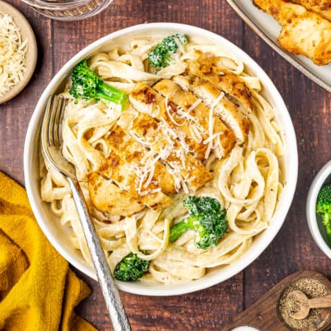 broccoli chicken alfredo in a bowl with a fork