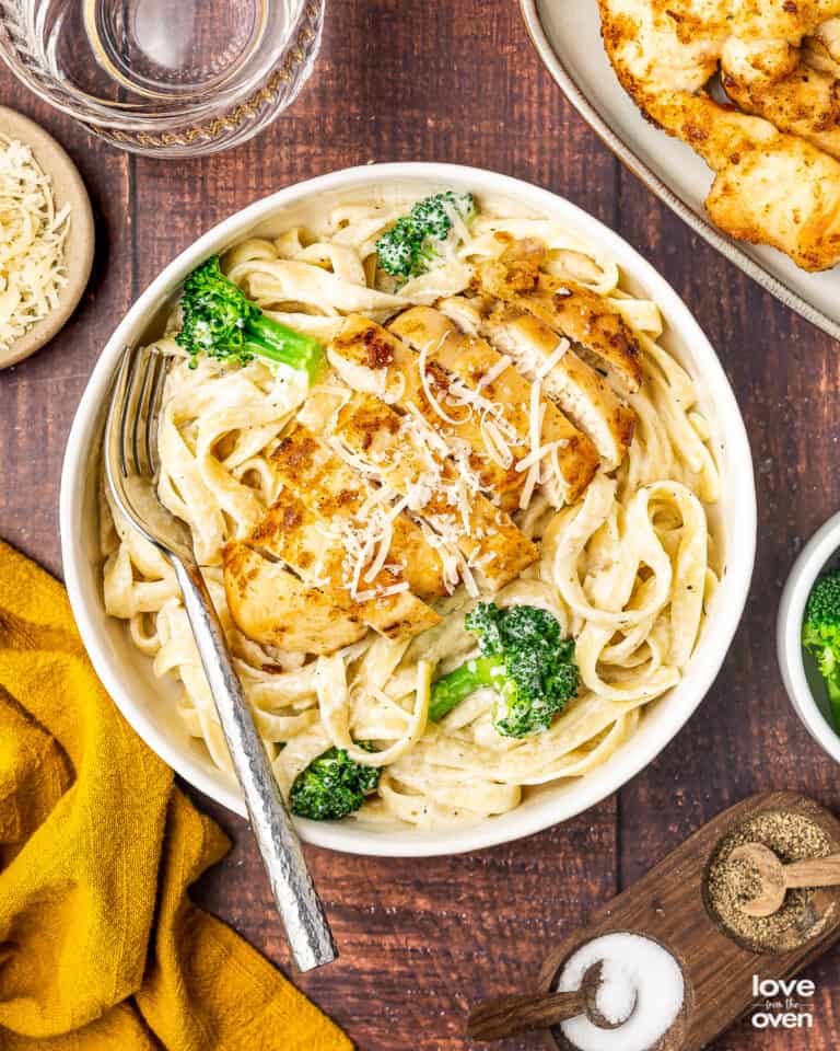 broccoli chicken alfredo in a bowl with a fork