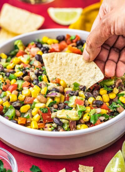a hand holding a chip scooping up some cowboy caviar