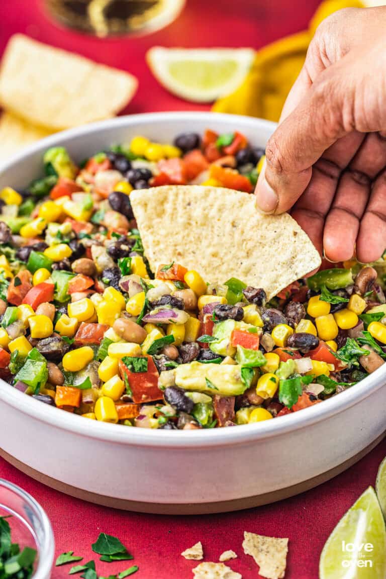 a hand holding a chip scooping up some cowboy caviar