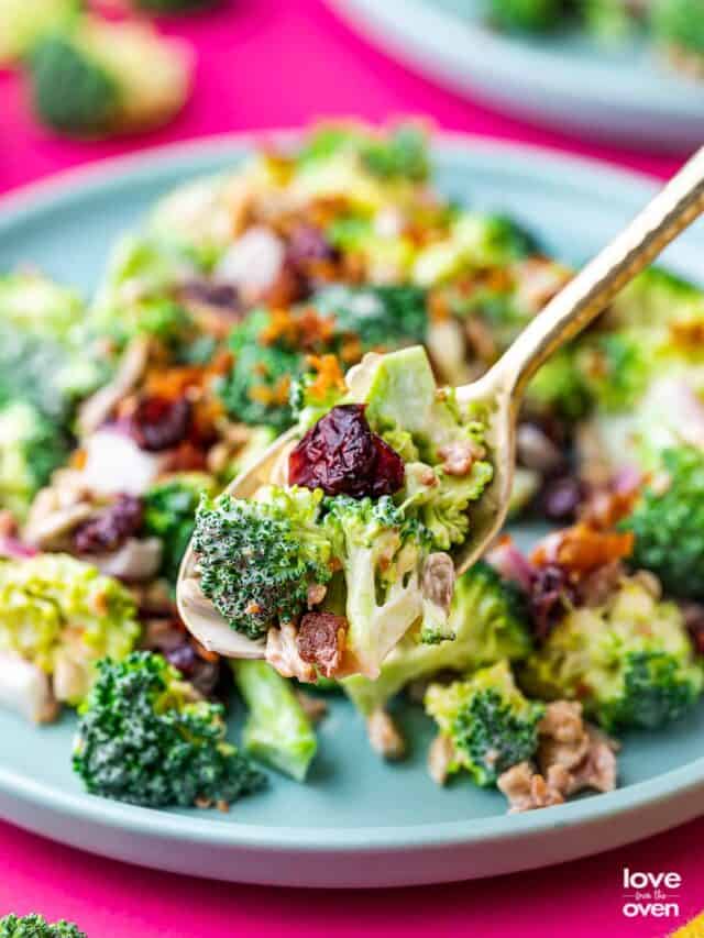 a spoon holding a spoonful of broccoli salad