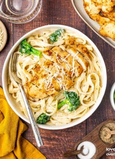 broccoli chicken alfredo in a bowl with a fork