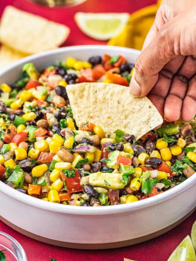 a hand holding a chip scooping up some cowboy caviar