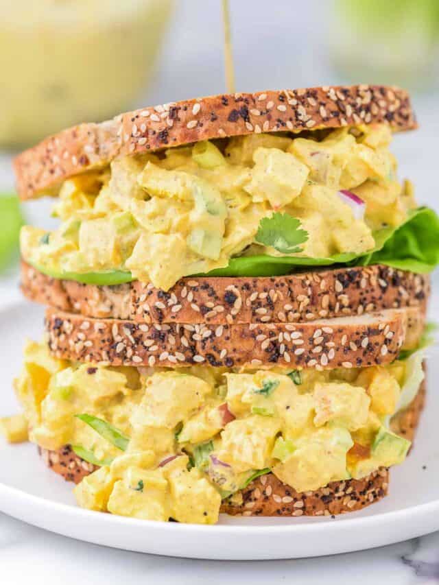 curried chicken salad sandwiches stacked on top of each other