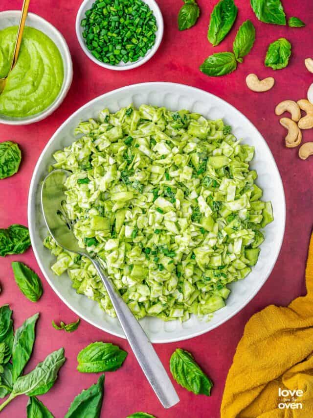 a plate of green goddess salad with a spoon in it