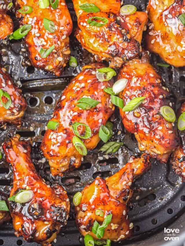 an air fryer basket of honey garlic chicken wings