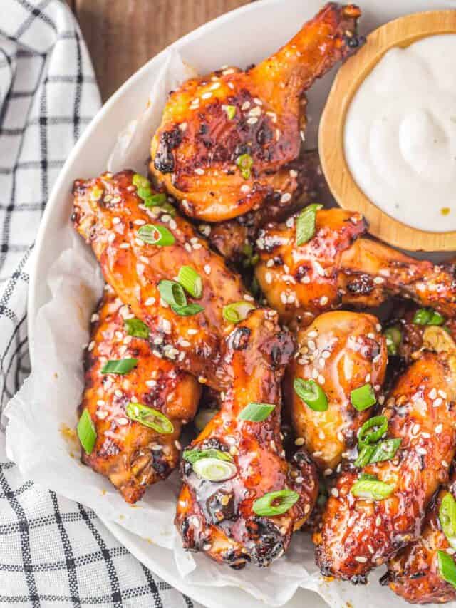 a plate of honey garlic chicken wings and ranch