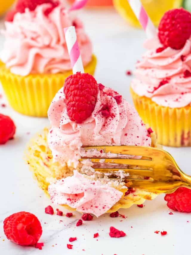 a fork digging into a raspberry lemon cupcake