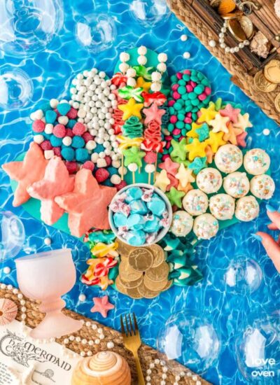 little mermaid snack board on an ocean background