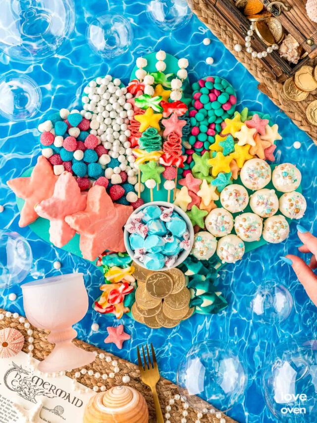 little mermaid snack board on an ocean background