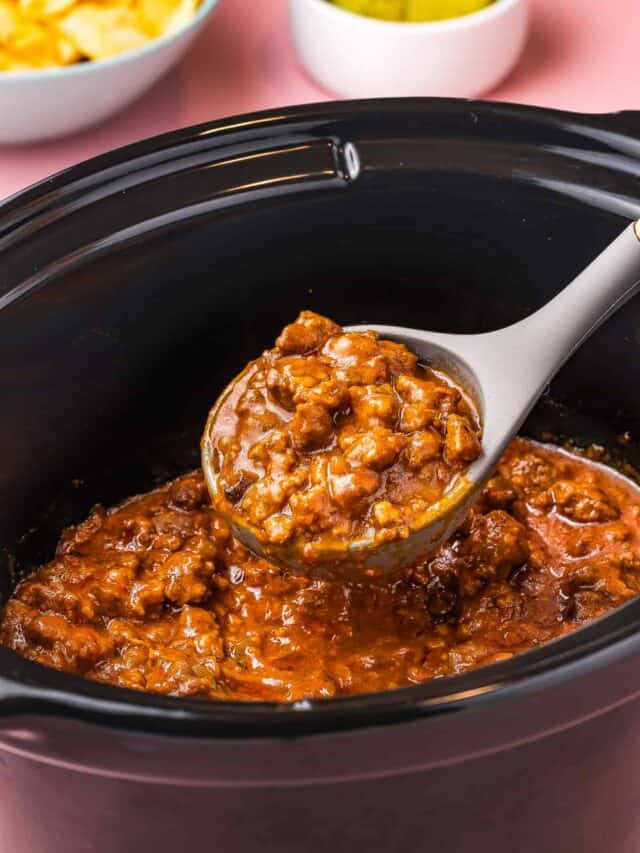 a ladle holding some crokpot sloppy joe filling