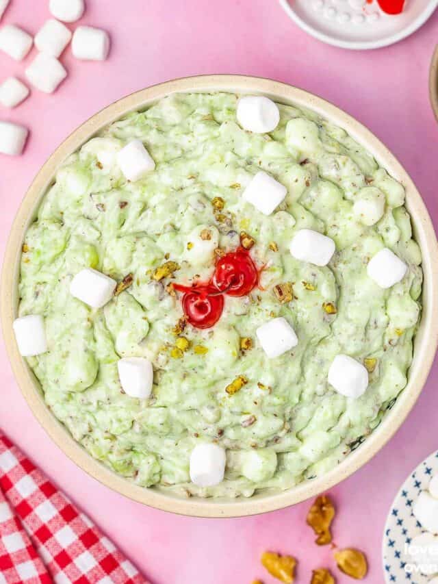 watergate salad in a bowl on a pink background