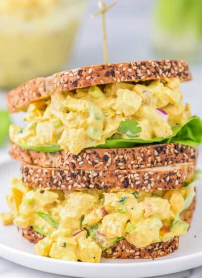 curried chicken salad sandwiches stacked on top of each other