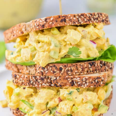 curried chicken salad sandwiches stacked on top of each other