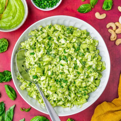 a plate of green goddess salad with a spoon in it