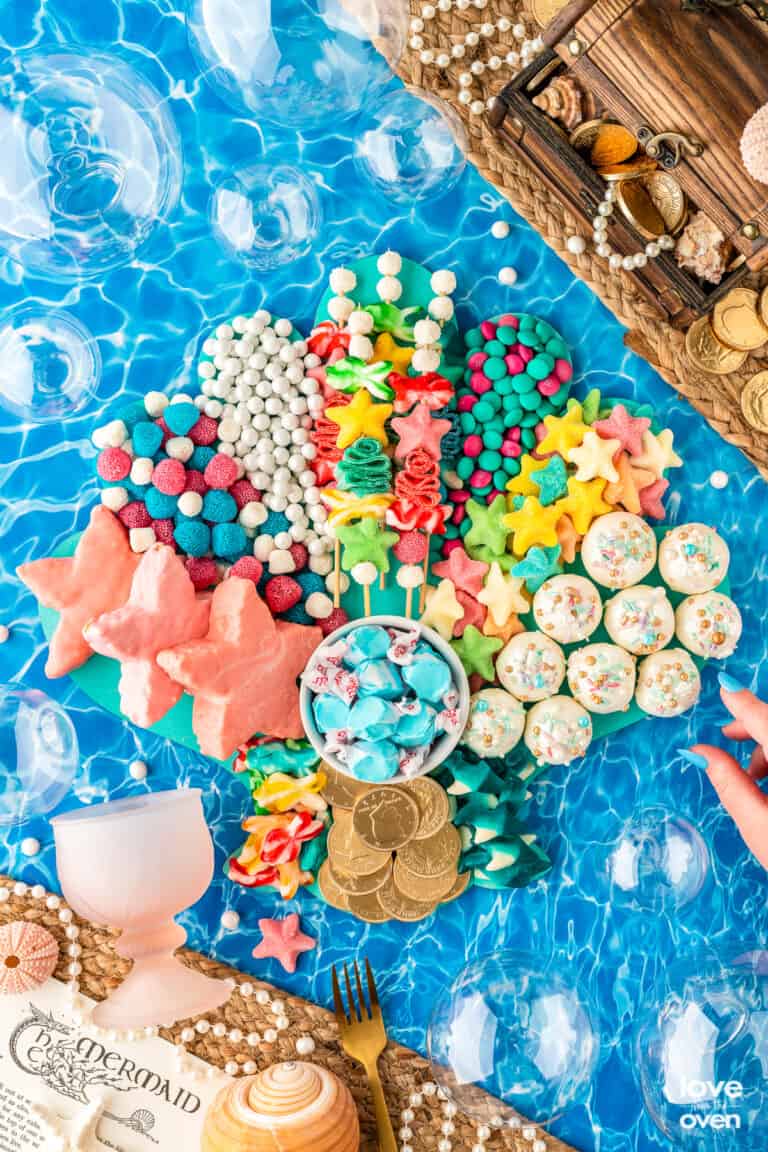 little mermaid snack board on an ocean background