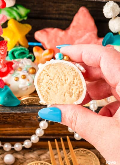 A hand holding an Oreo Truffle Ball that has been cut open.