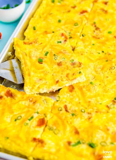 a close up of a spatula picking up some sheet pan eggs