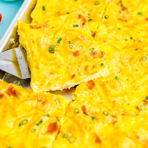 a close up of a spatula picking up some sheet pan eggs