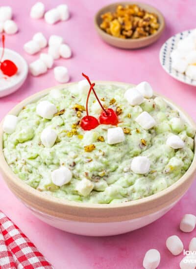 watergate salad in a bowl topped with cherries and marshmallows
